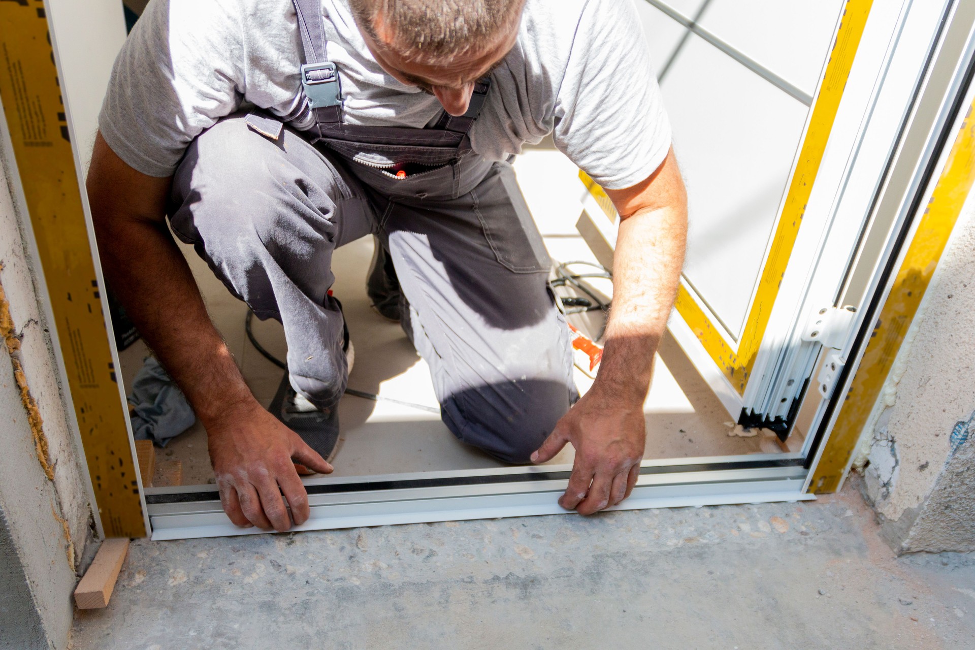 Professional carpenters installing an entrance door in a new apartment.